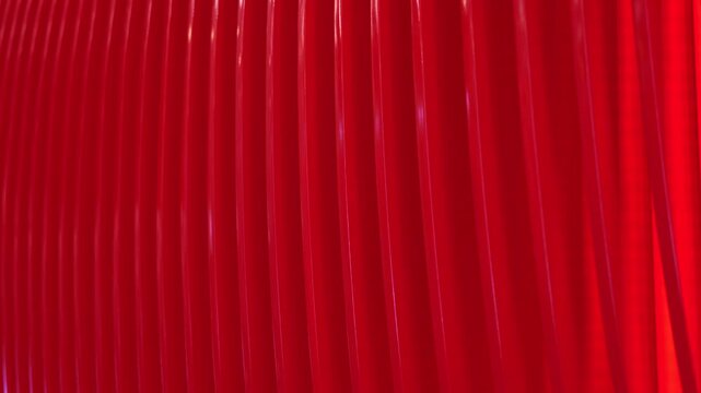 Repeating red curved lines creating modern abstract pattern and texture