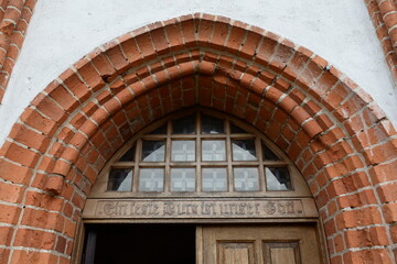 The inscription above the door of the Order's church reads: "Our God is a bulwark." Druzhba settlement, Kaliningrad region, Russia.