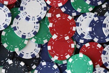 Close up of a group of casino chips on a green mat for poker or dice games indoors