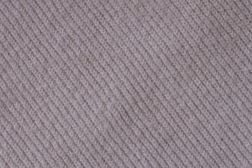 Texture of knitted pastel pink sweater, close-up texture of beige pink