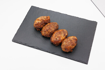Four Grilled Abkhazura Sausages On Black Slate Platter Ready To Serve As Appetizers