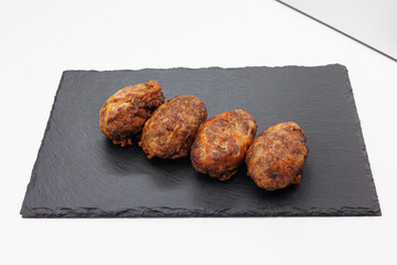Four Grilled Abkhazura Sausages On Black Slate Platter Ready To Serve As Appetizers