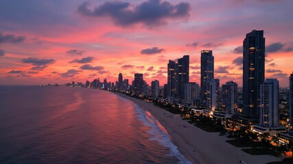 Panoramic view of a coastal city skyline at dusk with dramatic pink and purple clouds - Powered by Adobe