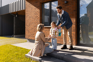 Caring parents preparing child for school morning at home