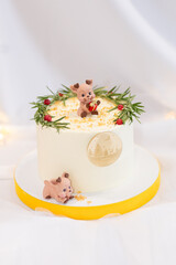 christmas white cake decorated. with branches and little pig on top. white background