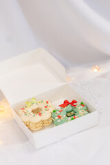 macaron dessert in shape of christmas wreath. homemade unique cookie. bow and sprinkles. white and green. isolated