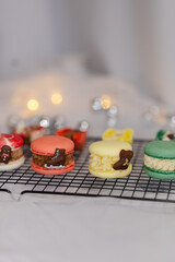 macaron dessert for christmas. homemade unique cookie. bow and sprinkles. various colors. present box. white