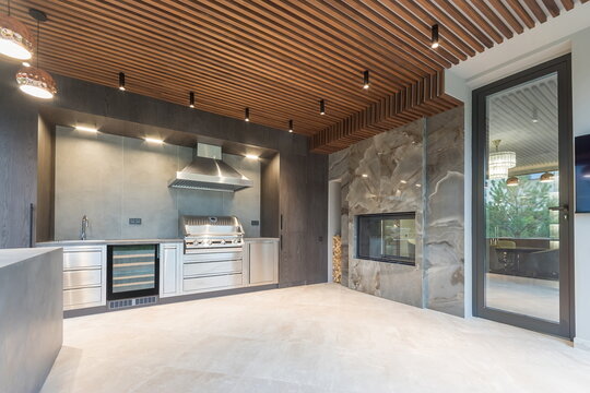 Modern kitchen design with sleek finishes and large windows showcasing outdoor view