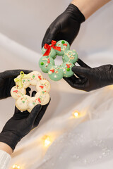macaron dessert in shape of christmas wreath. homemade unique cookie. bow and sprinkles. white and green. isolated