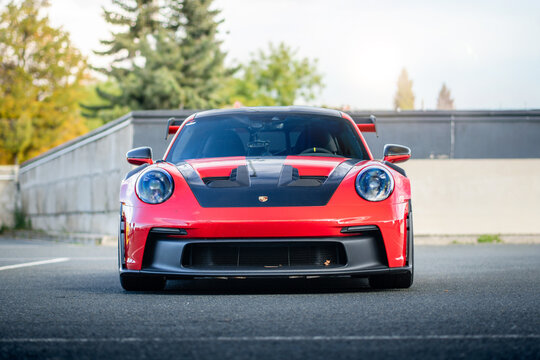 Brno, Czech Republic - October 24, 2025: Red Porsche 911 GT3 RS sports car outdoors in a parking lot at a race track.