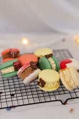 macaron dessert for christmas. homemade unique cookie. bow and sprinkles. various colors. present box. white