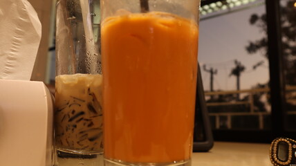 drinks on a table with a cafe in the background.