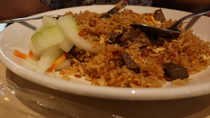 Enjoy fried rice with meat topping, a signature Indonesian food.