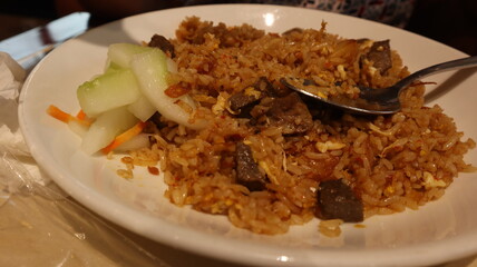 Enjoy fried rice with meat topping, a signature Indonesian food.