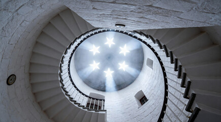 Fototapeta premium Spiral Staircase Looking Up at Star Shaped Ceiling Lights