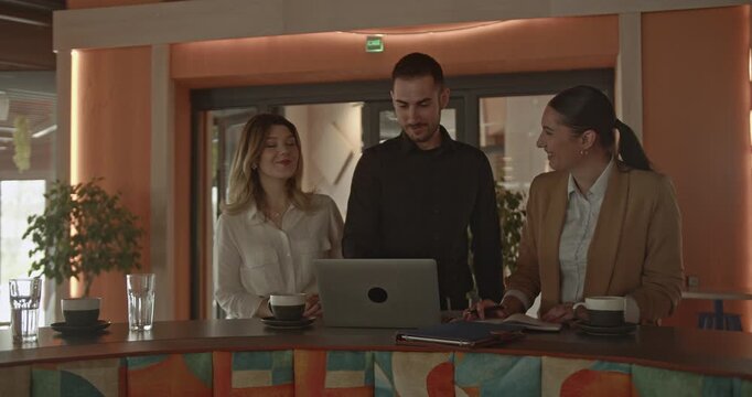 Professional business partners discuss strategies for growing their small business, collaborating effectively with a laptop in a modern workspace. Their teamwork ensures future success.