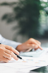 Finance bank tax expense accounting budget money businessman hand use calculator Financial calculate accountant close up calculator with graph chart write office desk Business expense analysis saving