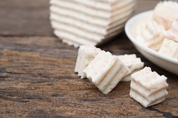 Fresh sliced taro root on wood background