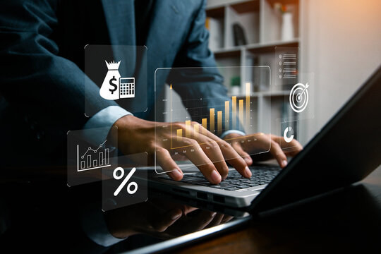 Businessman analyzing financial data and digital marketing charts on laptop, focusing on growth, profit, and investment strategy using futuristic technology and virtual analytics interface.