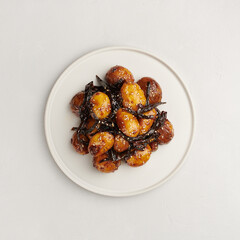 Gamja Jorim, Korean braised baby potatoes on white background, top view