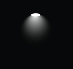 A single, bright spotlight shines down from above, casting a soft, circular pool of light against a deep black background. The light source itself is a brilliant white, gradually fading outwards into 