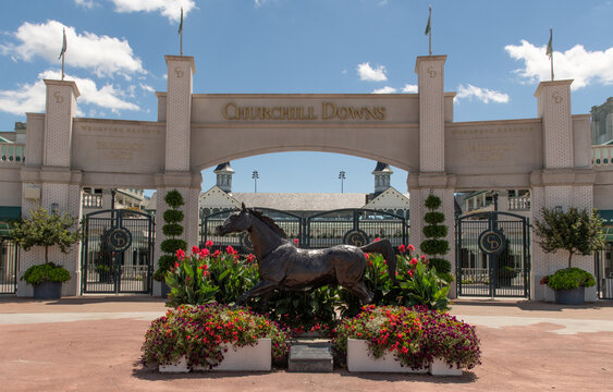 Horizontal photo of the Grand Entrance to the Kentucky Derby at Churchill Downs in Louisville Kentucky.  Shown is a sculpture of a thoroughbred, horse.