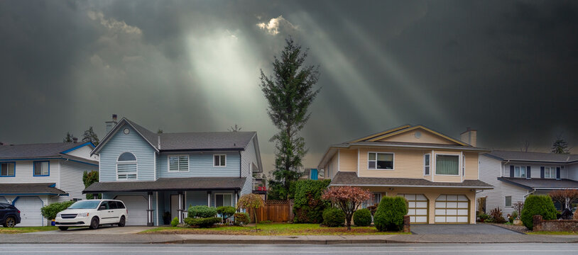 Row of residential houses on stormy sky background