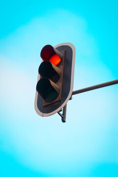red traffic light on blue sky