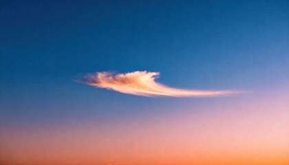 Celestial Wave: A wispy cloud, delicately sculpted by the wind, dances across a gradient sky, painting a serene and breathtaking scene of nature's artistry.