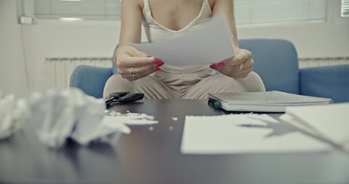 A woman is shown meticulously tearing, folding, and crumpling paper, creating a variety of satisfying and calming sounds. This ASMR-inspired video focuses on the intricate auditory textures.