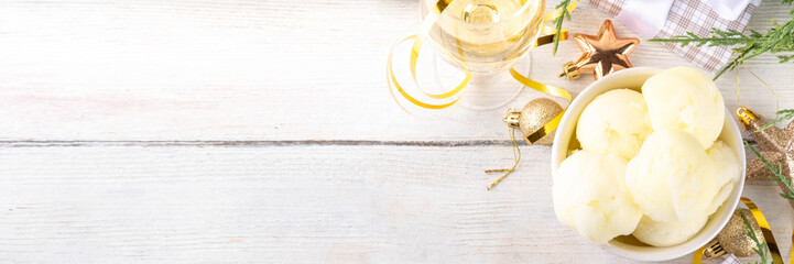 Tasty Champagne ice cream, Christmas taste white brut wine sorbet, with champagne glass and bottle on New Year and Christmas decorated background