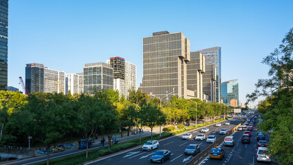 Modern city street with tall buildings and heavy traffic