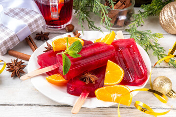 Tasty winter mulled wine ice cream popsicles. Frozen mulled wine cocktail on sticks, traditional...