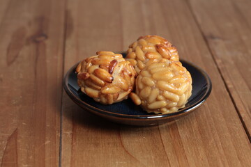 Traditional catalan panellets, a sweet almond and pine nut pastry, making a delicious dessert or snack on a rustic wooden surface