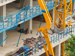 Construction Workers Among Reinforcement Bars and Heavy Equipment