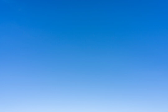 A clear and bright blue sky with no clouds visible - Powered by Adobe