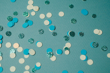 Colorful confetti scattered on a blue background for celebration or event