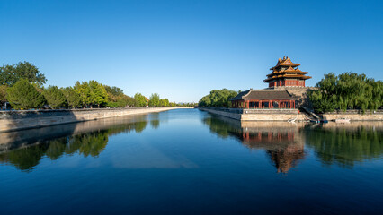 The beautiful reflection of the Forbidden City corner tower in the water