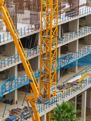 Construction Workers Among Reinforcement Bars and Heavy Equipment
