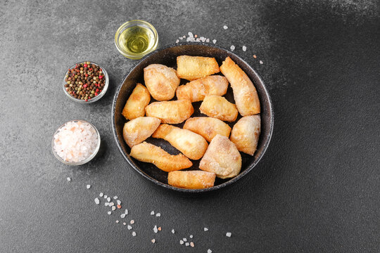 Garlic breadsticks in black bowl on dark background for appetizer, snack or pizza side concept - Powered by Adobe