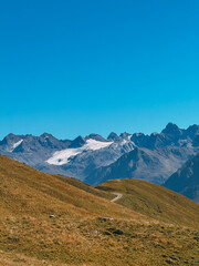 Mountain road winding through alpine peaks and glaciers