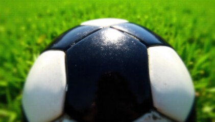 A close up macro shot of a textured soccer ball against the sharp, vibrant green blades of a sports field, emphasizing detail. Extreme macro photograph focusing on the detailed texture of a soccer