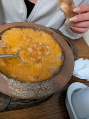 hand holding a bowl of beens