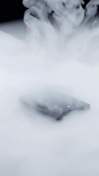 Sleek SSD on White Desk Immersed in Liquid Nitrogen Slow Motion