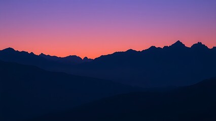 Fototapeta premium Majestic mountain peaks silhouetted against a twilight sky with a natural glow.