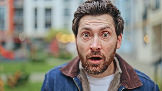 Captures expressive face showing deep surprise. Eyes wide, mouth open, conveying shock and wonder. Reveals intense emotional reaction to something unexpected. Engaging and relatable human moment.