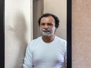 man prepares for his daily shave