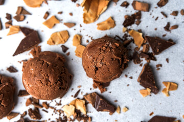  Chocolate ice cream scoops with waffle pieces and chocolate chunks on light surface