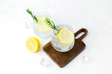 Lemon cocktail with rosemary on wooden board
