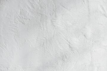 Textured white concrete wall surface with subtle shadows and fine grain details